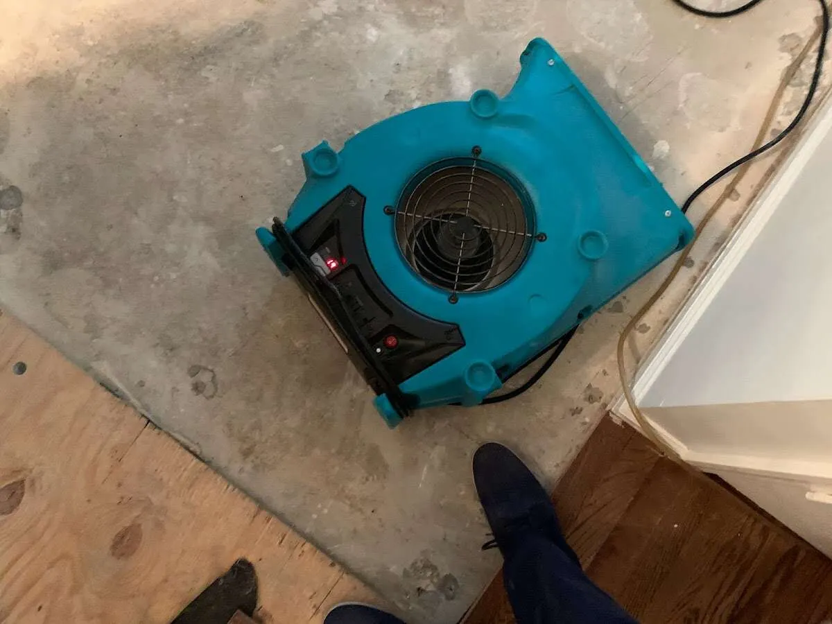 Air mover drying subfloor during Commercial Water Damage Restoration in Lake Wales